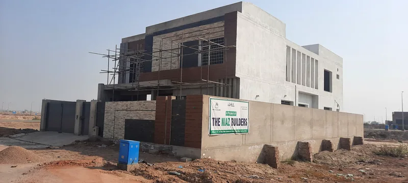 House 469 Sector Q DHA Multan front elevation finishing stage with scaffolding and Niaz Builders banner 2020
